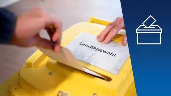 Eine gelbe Wahlurne mit Stimmzettel. | Sebastian Gollnow Eine gelbe Wahlurne mit Stimmzettel.